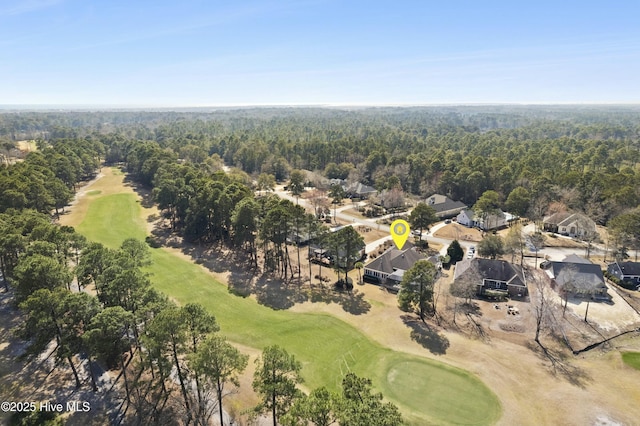 aerial view with view of golf course and a wooded view