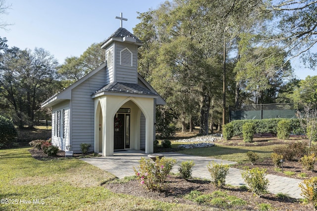 view of community featuring a yard and fence