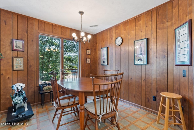 dining space featuring a chandelier, light floors, visible vents, and baseboards