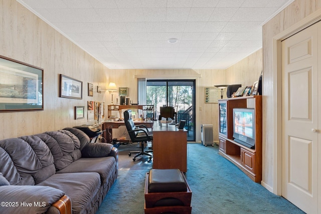 office area featuring radiator, wood walls, carpet floors, and ornamental molding