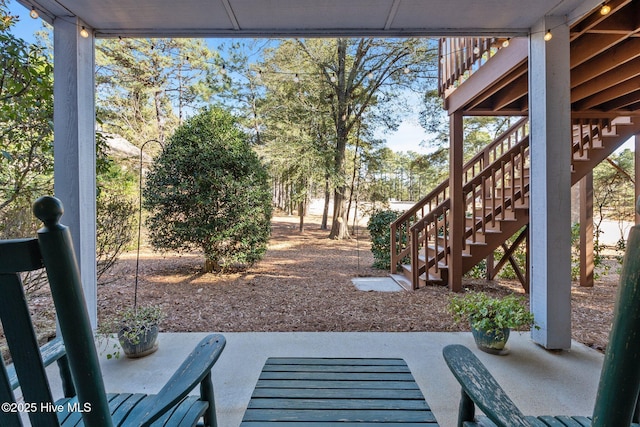 view of yard with a patio area and stairs