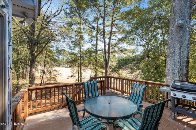 deck featuring a grill and outdoor dining space