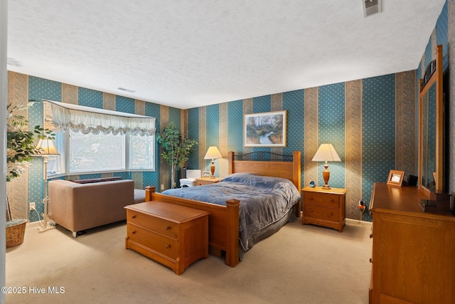 bedroom with light carpet, wallpapered walls, and a textured ceiling