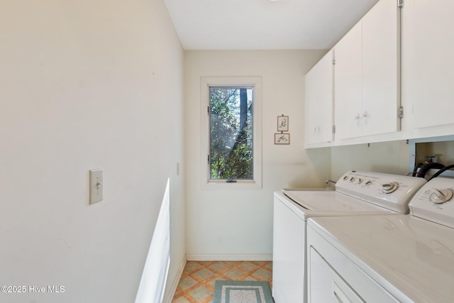 laundry area with light floors, separate washer and dryer, cabinet space, and baseboards