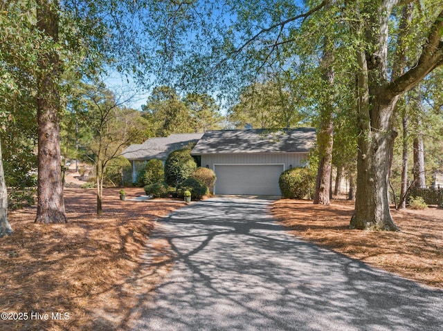 mid-century inspired home featuring a garage and driveway