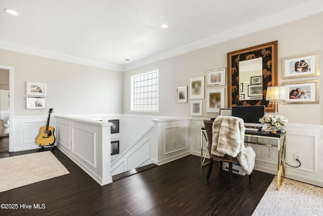 office area featuring a wainscoted wall, ornamental molding, and dark wood-type flooring