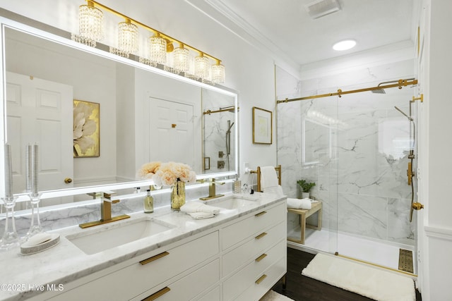 bathroom featuring visible vents, a sink, a marble finish shower, and double vanity