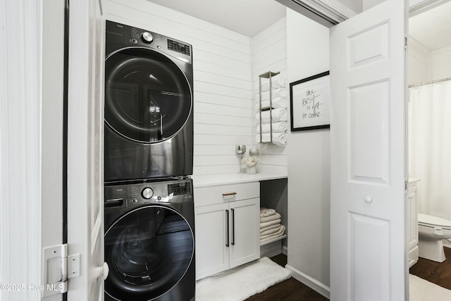 clothes washing area featuring stacked washer and dryer