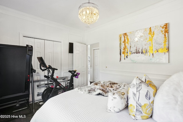 bedroom featuring ornamental molding, a chandelier, and a closet