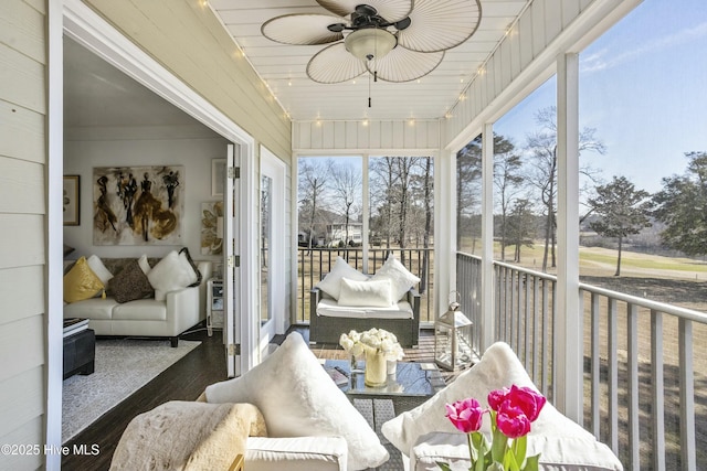 sunroom with a ceiling fan