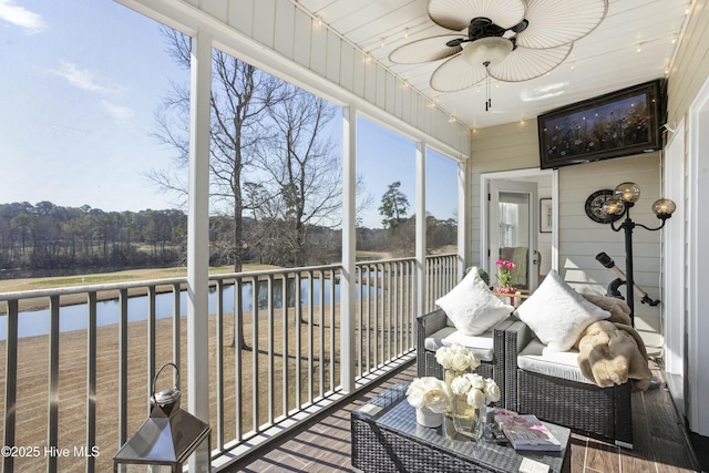 sunroom / solarium with a water view