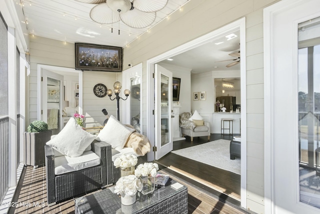 sunroom featuring ceiling fan