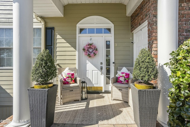 doorway to property featuring brick siding