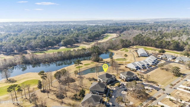 birds eye view of property featuring a water view, view of golf course, and a view of trees