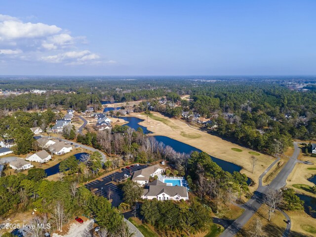 aerial view featuring a water view and a wooded view