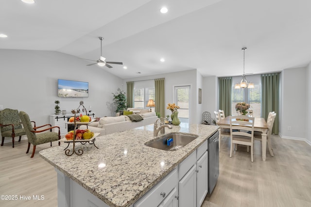 kitchen featuring stainless steel dishwasher, plenty of natural light, a sink, and light wood-style flooring