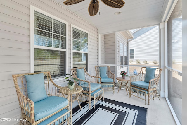 sunroom featuring a wealth of natural light and a ceiling fan