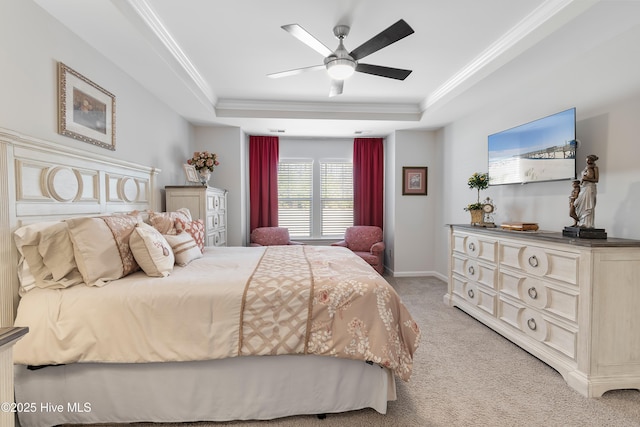 bedroom with ornamental molding, a raised ceiling, a ceiling fan, and light colored carpet