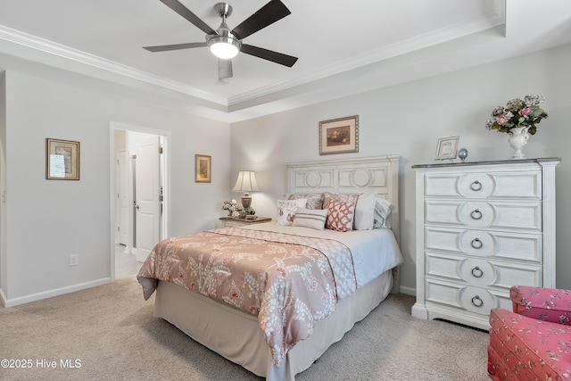 bedroom featuring carpet floors, a raised ceiling, and crown molding