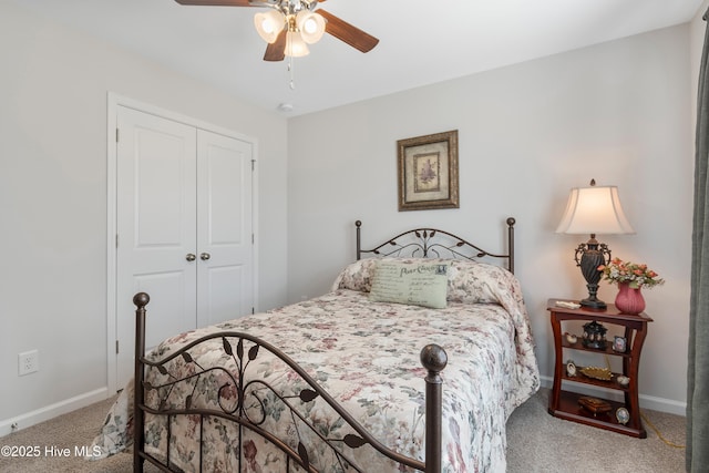 carpeted bedroom featuring a closet, ceiling fan, and baseboards