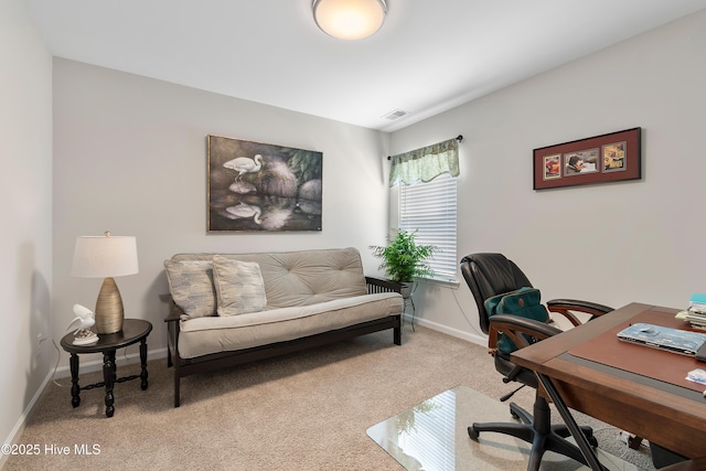 office area with light colored carpet, visible vents, and baseboards