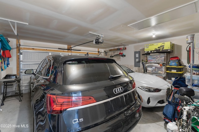 garage with electric panel and a garage door opener