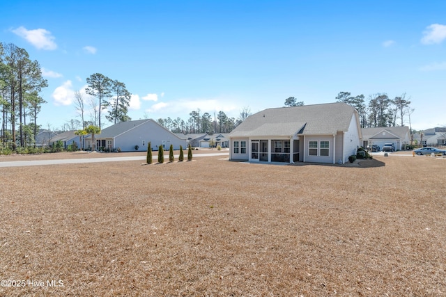 rear view of house with a sunroom