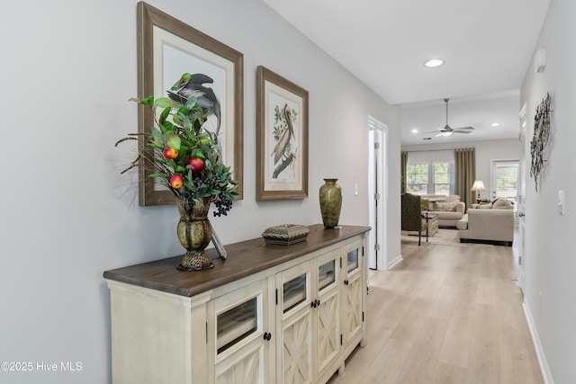 hall featuring recessed lighting, light wood-type flooring, and baseboards