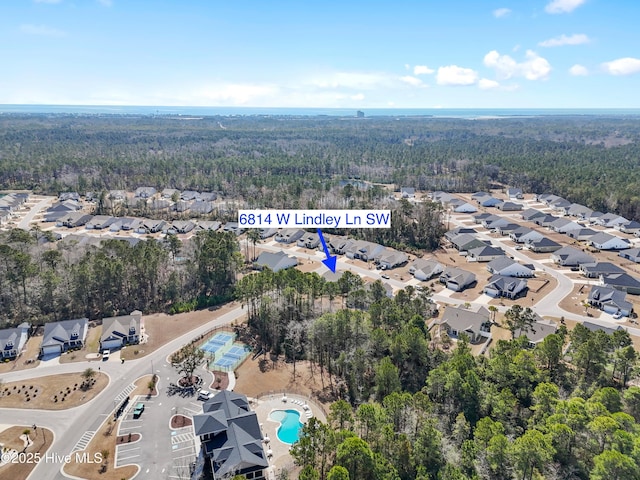 birds eye view of property with a forest view and a residential view