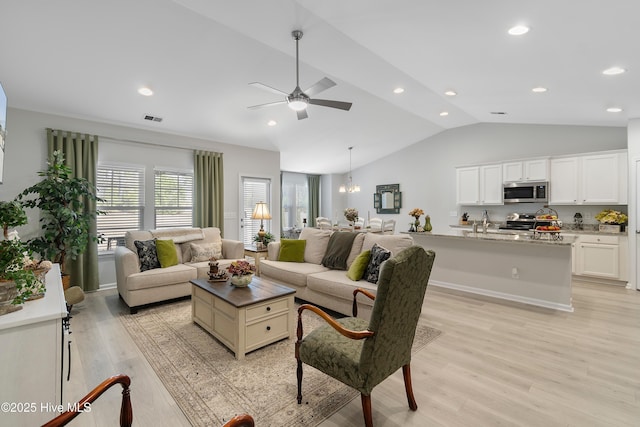 living area with lofted ceiling, recessed lighting, visible vents, light wood-style floors, and ceiling fan