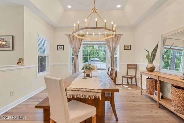 122 Smathers Dr, West End, NC 27376 - dining area with light wood-style flooring, a chandelier, baseboards, and vaulted ceiling