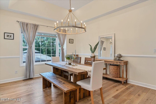 122 Smathers Dr, West End, NC 27376 - dining area featuring light wood-style flooring, a chandelier, and baseboards