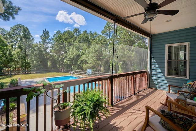 122 Smathers Dr, West End, NC 27376 - wooden terrace featuring a fenced backyard, a ceiling fan, an outdoor pool, and view of wooded area