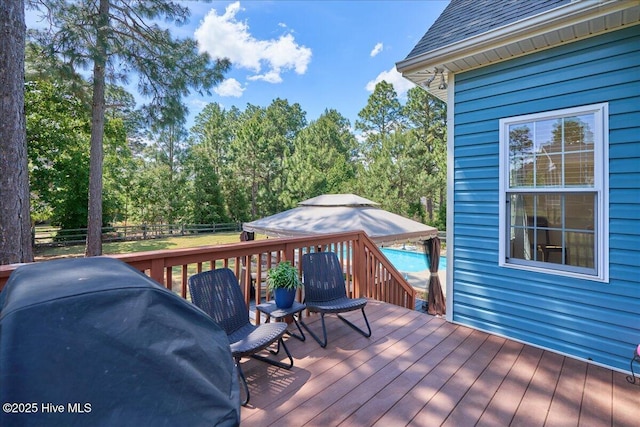 122 Smathers Dr, West End, NC 27376 - wooden deck with a fenced backyard, outdoor dining area, and area for grilling