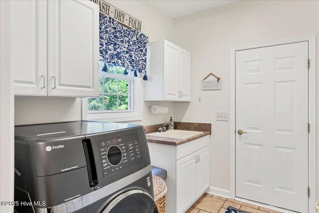 122 Smathers Dr, West End, NC 27376 - laundry area with cabinet space, light tile patterned floors, and washing machine and clothes dryer