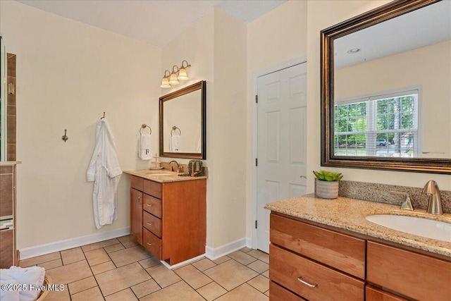 122 Smathers Dr, West End, NC 27376 - bathroom with baseboards, two vanities, and tile patterned flooring