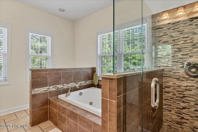 122 Smathers Dr, West End, NC 27376 - full bath featuring tile patterned flooring, a shower stall, a jetted tub, and baseboards