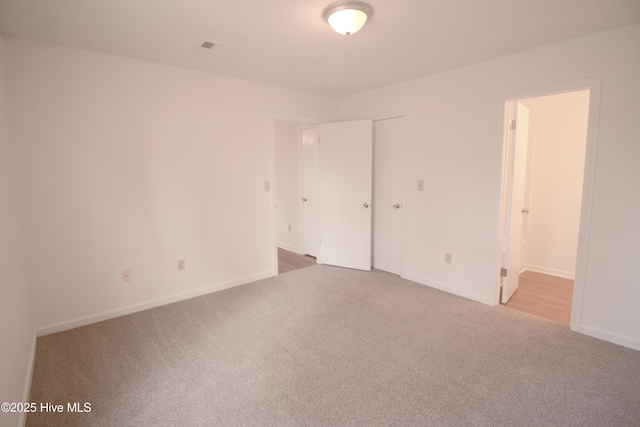 empty room with carpet floors and baseboards