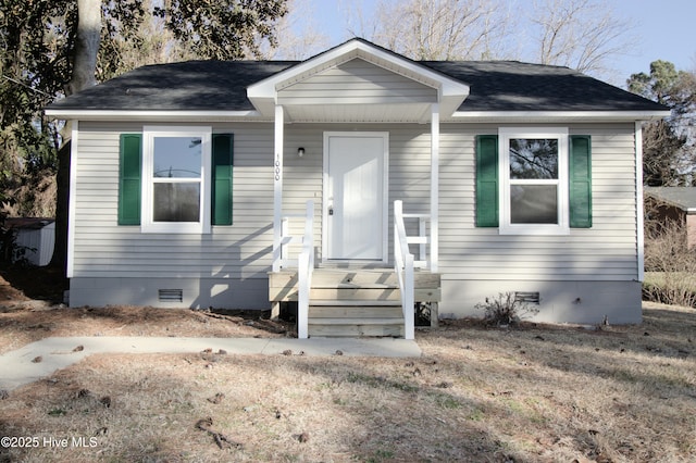 bungalow with a shingled roof and crawl space