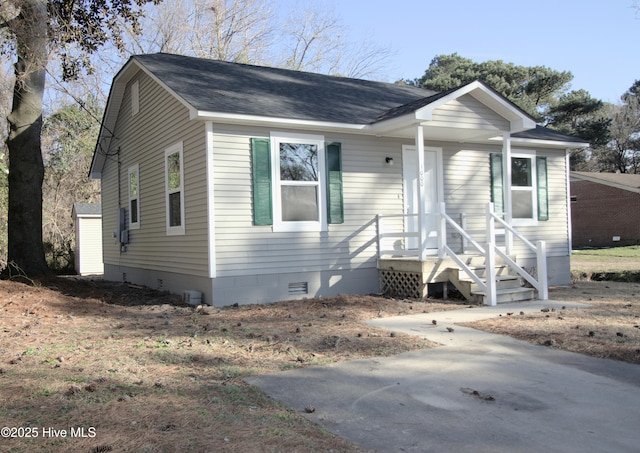 view of front of home with roof with shingles and crawl space