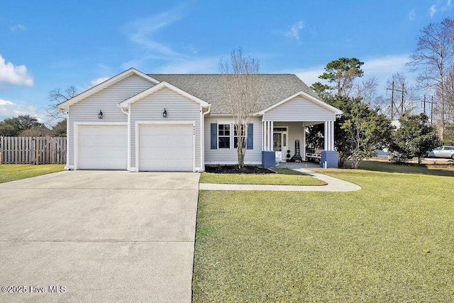 view of front of home with a garage, a shingled roof, fence, concrete driveway, and a front yard