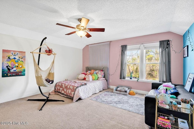 carpeted bedroom with lofted ceiling, ceiling fan, a textured ceiling, and baseboards