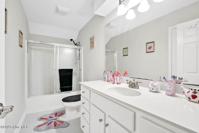 bathroom with visible vents, toilet, combined bath / shower with glass door, vanity, and tile patterned flooring