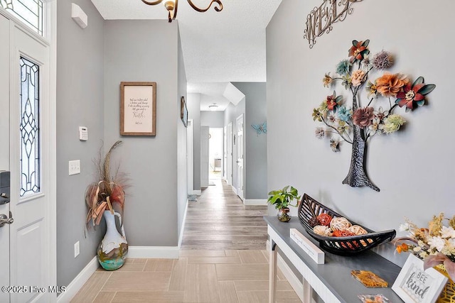 foyer featuring plenty of natural light and baseboards