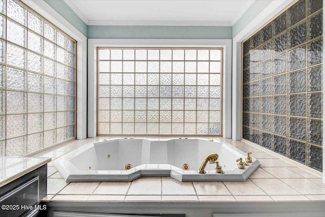 bathroom with ornamental molding and a jetted tub