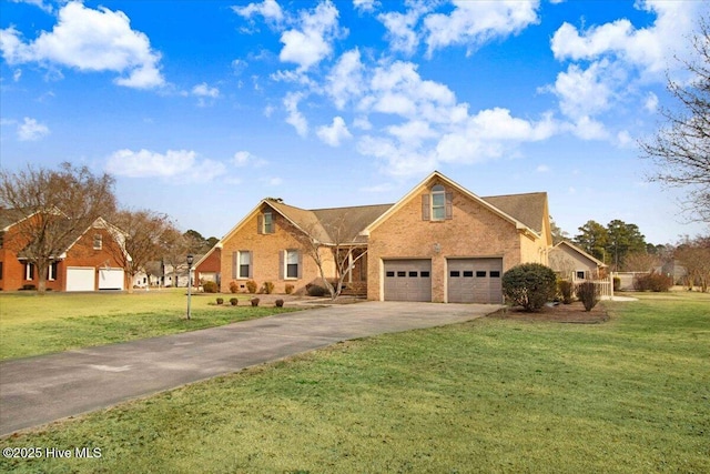 traditional-style home featuring a garage, a front yard, brick siding, and driveway