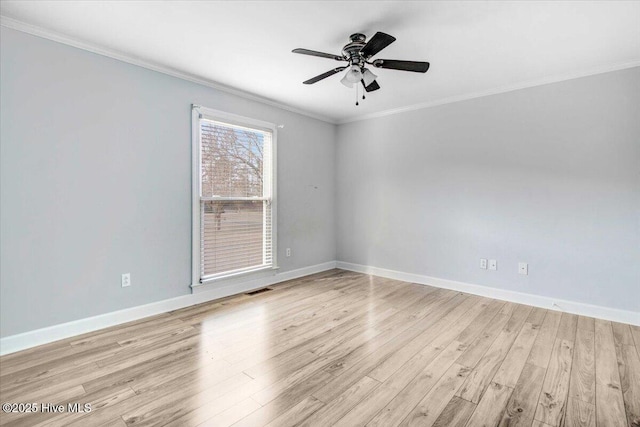 empty room featuring visible vents, baseboards, a ceiling fan, ornamental molding, and light wood-style floors