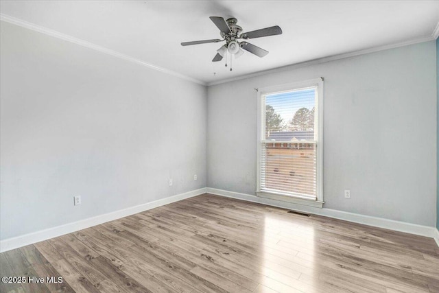 unfurnished room featuring visible vents, crown molding, baseboards, and wood finished floors