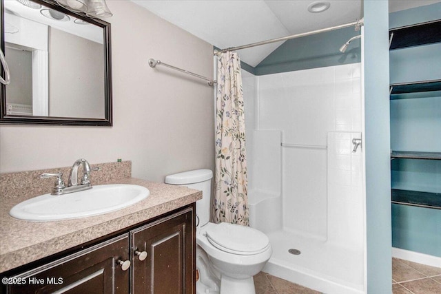 full bathroom with tile patterned flooring, toilet, and a shower with curtain