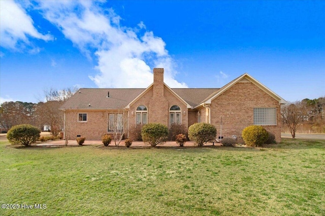 view of front facade featuring crawl space, a chimney, a front lawn, and brick siding